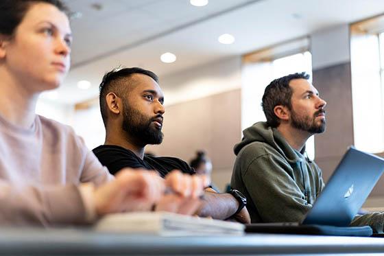 Students pay attention and take notes in a lecture